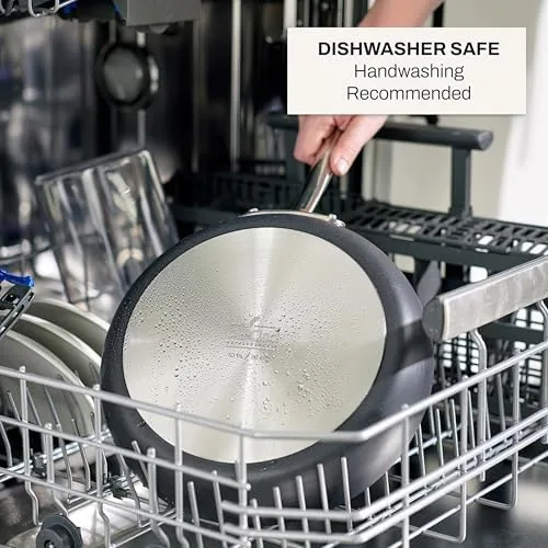 The two pans in a kitchen drawer rack with other cookware