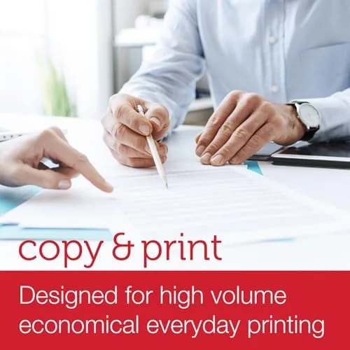 Stack of freshly printed pages next to an open ream
