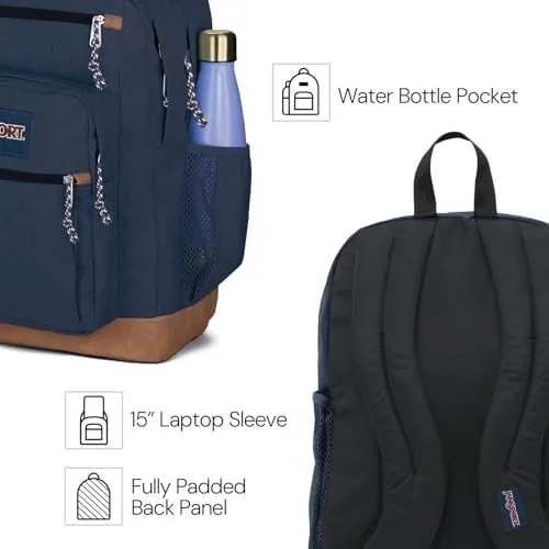 The JanSport Cool Backpack on a chair beside a laptop and notebooks