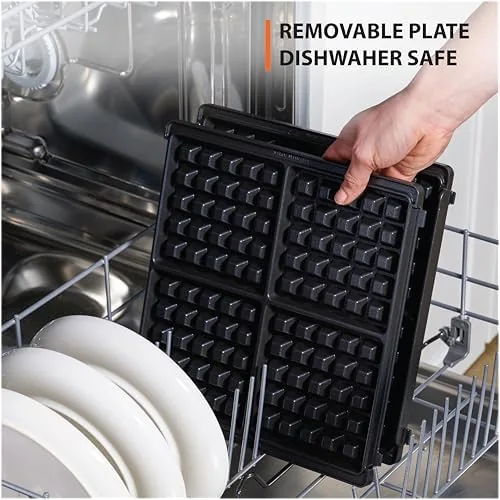 Four finished Belgian waffles stacked on a serving plate