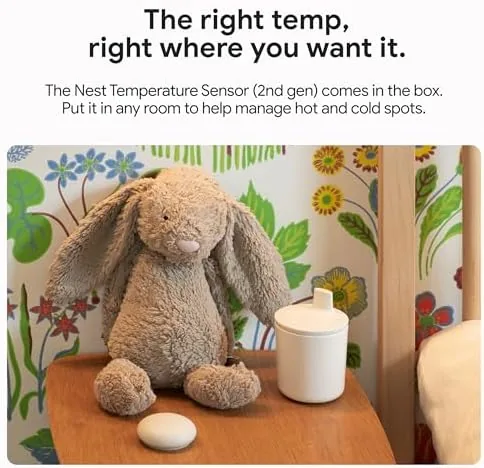 Hand rotating the metal ring on the Google Nest Learning Thermostat to change the temperature
