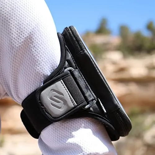 A phone in a protective case being inserted into the Entropy E8 running armband pocket