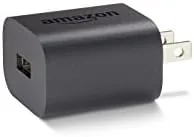 Amazon 5W charger powering a Fire tablet on a nightstand