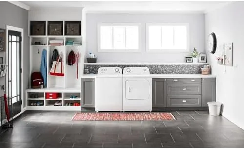 A basket of clean folded laundry beside the Amana washer showing the load it handles