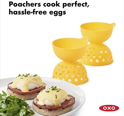 An egg cracked into the OXO silicone cup with water around it