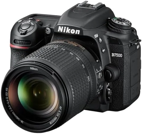 The Nikon D7500 with the 18-140mm lens attached on a camera strap