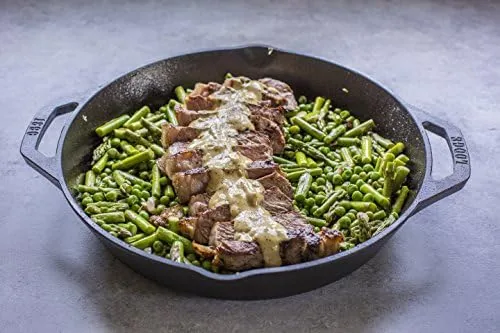 The Lodge 12 inch cast iron pan held with both handles showing the dual grip design
