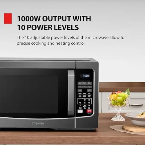 The Toshiba microwave sitting on a kitchen counter with a mug being placed inside