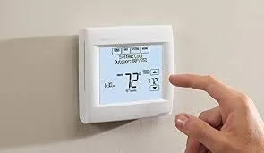 The Total Connect Comfort app on a phone showing the thermostat schedule