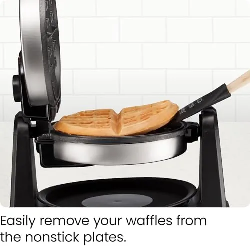 The waffle maker flipped open with batter spreading evenly across the plates