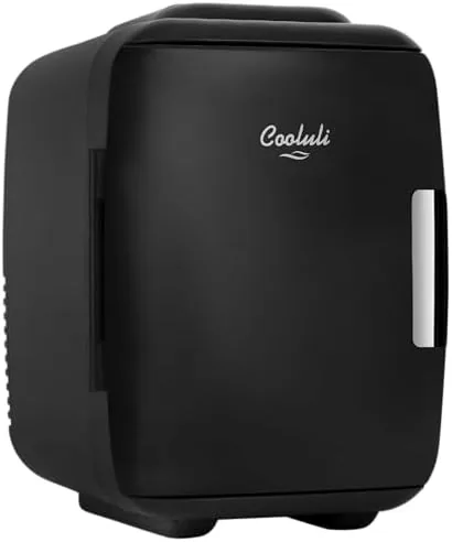 The black Cooluli mini fridge sitting on a bedroom nightstand