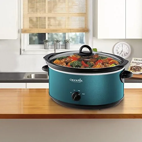 Glass lid lifted to show a large roast inside the stoneware insert