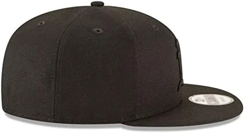 The snapback cap beside a fitted cap
