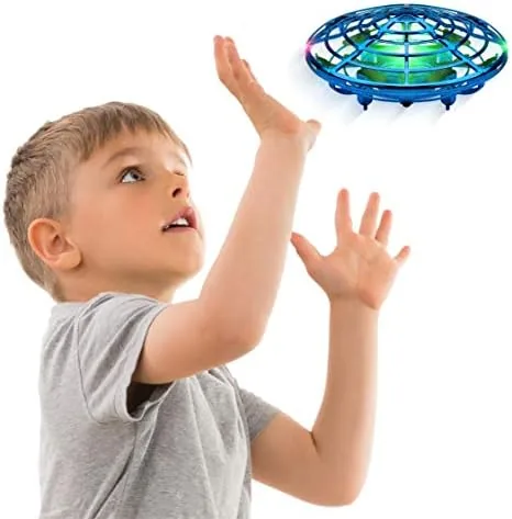 The blue Force1 Scoot drone hovering above an open palm indoors