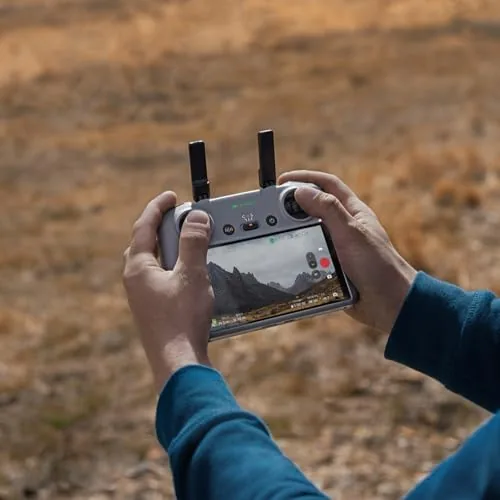 DJI RC 2 next to a phone-mounted controller showing the size difference