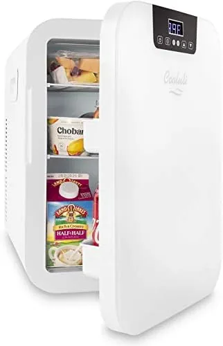 Cold soda can being removed from the Cooluli mini fridge