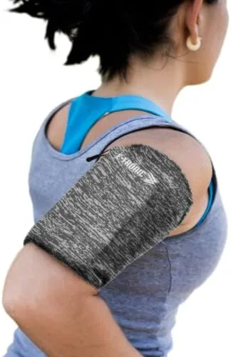 A runner wearing the phone arm band while running on a path