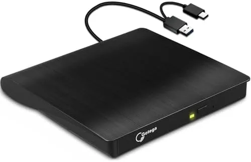 The external USB-C CD/DVD drive sitting on a desk next to a laptop