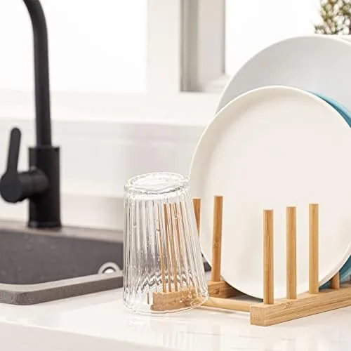 Plates and bowls resting upright in the bamboo dish rack slots
