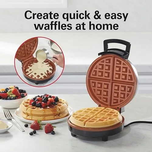 A finished Belgian waffle with syrup poured into the deep pockets