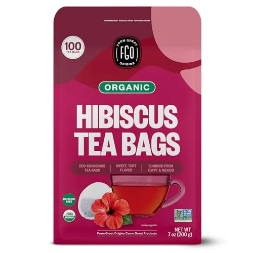 A box of FGO organic hibiscus tea beside a glass mug of brewed tea