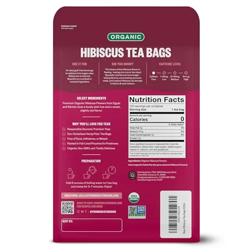A single unbleached tea bag steeping in a clear glass mug of hot water