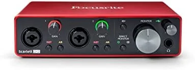 Focusrite Scarlett 2i2 3rd Gen sitting on a desk beside a microphone