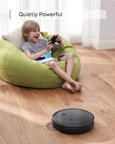 The remote control of the eufy 11S MAX next to the vacuum body