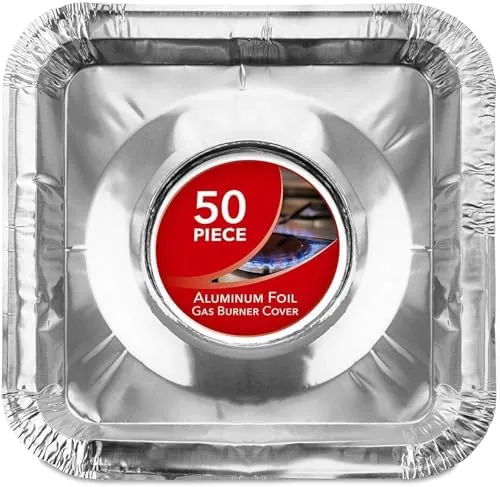 A stack of aluminum foil burner liners held above a gas stove