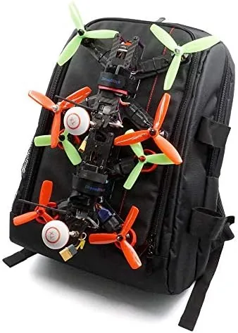 A pilot walking a trail with an FPV quad secured to a backpack