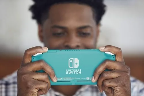 The Switch Lite Turquoise packed into a small carry case with games