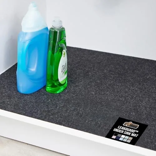 The Gorilla Grip LeakGuard mat laid flat inside a kitchen sink cabinet