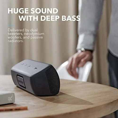 The Motion+ speaker playing music on a patio next to a lounge chair