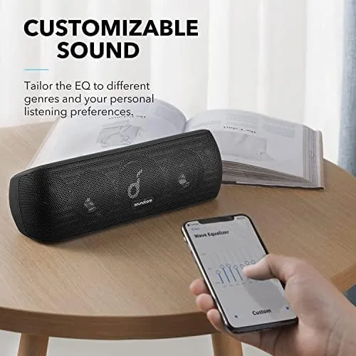 The Motion+ sitting beside a JBL speaker on a table for a size comparison