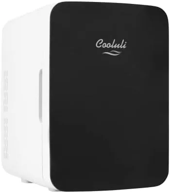 The black Cooluli 10L mini fridge sitting next to a gaming desk