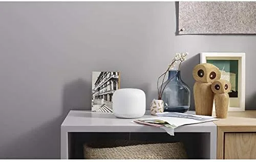 The Nest Wifi point playing music in a kitchen with the assistant speaker in use