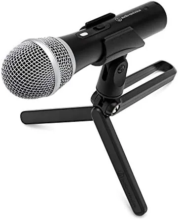 Audio-Technica ATR2100X-USB microphone on a desk with a podcast setup