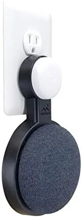 Google Nest Mini mounted on a wall outlet in a kitchen