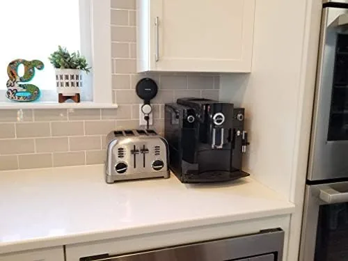 The mount plugged into a wall outlet with the Nest Mini snapped in place