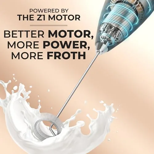 Frother creating foam in a glass of warm milk
