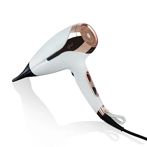 ghd Helios hair dryer held in a hand against a neutral background