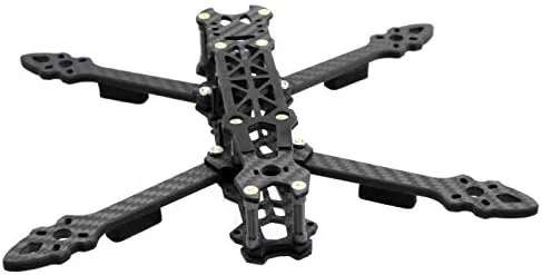 Completed FPV drone hovering low over grass during a test flight