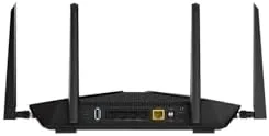 The Nighthawk RAX50 mounted on a wall in a home media cabinet