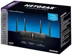 A reviewer running a network speed test with the Nighthawk RAX50 router nearby