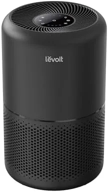 The black Levoit Core 300 air purifier sitting on a bedroom floor