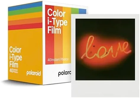 A new pack of Polaroid i-Type color film beside a Polaroid camera
