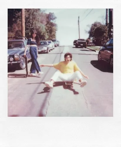 A developed instant photo showing a garden scene in outdoor light