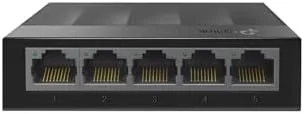 The TP-Link LS1005G switch sitting on a desk with ethernet cables connected
