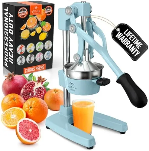 The Zulay cast iron juicer on a kitchen counter with oranges nearby