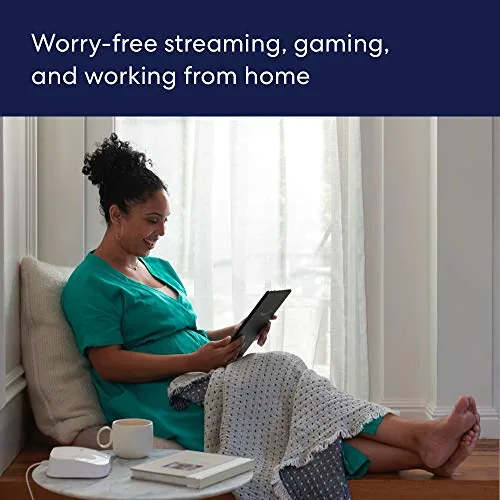 A family using several devices in a living room served by the mesh network
